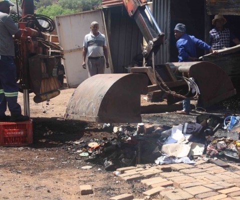 Charred belongings being cleaned up. Photo Selogile Leshage