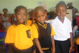 Kutlwano Segotso, Kamogelo Kemeng, and Boitumelo Motsapi of Nanogang Primary School are ecstatic about starting school.