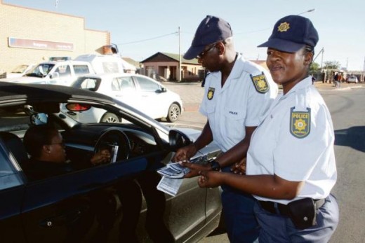 Const. Morwa Mahery-Moshou and Const. Mosiane Moeketsi give out flyers containing important crime prevention information. Photo: Selogile Leshage