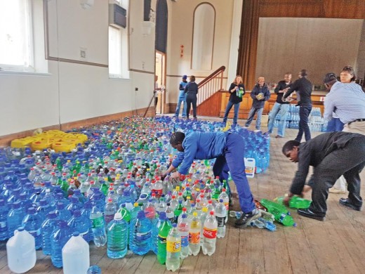 The community of Kroonstad receiving the water bottles from Potchefstroom Central School. 