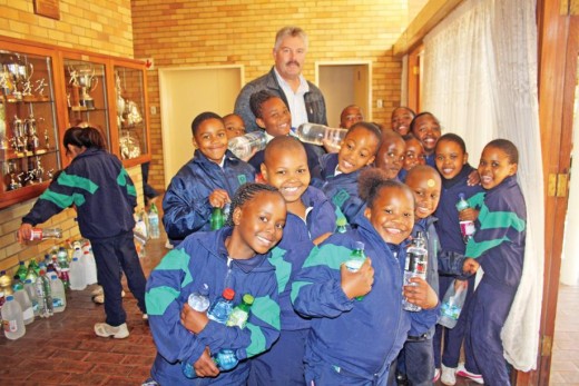 Headmaster of Potchefstroom Central School, Chris Van den Berg poses with the learners who were loading water onto the trucks.  Photo: Selogile Leshage
