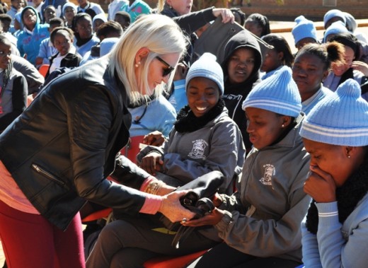 Charlotte van Alphen hands over handbags to the girls.