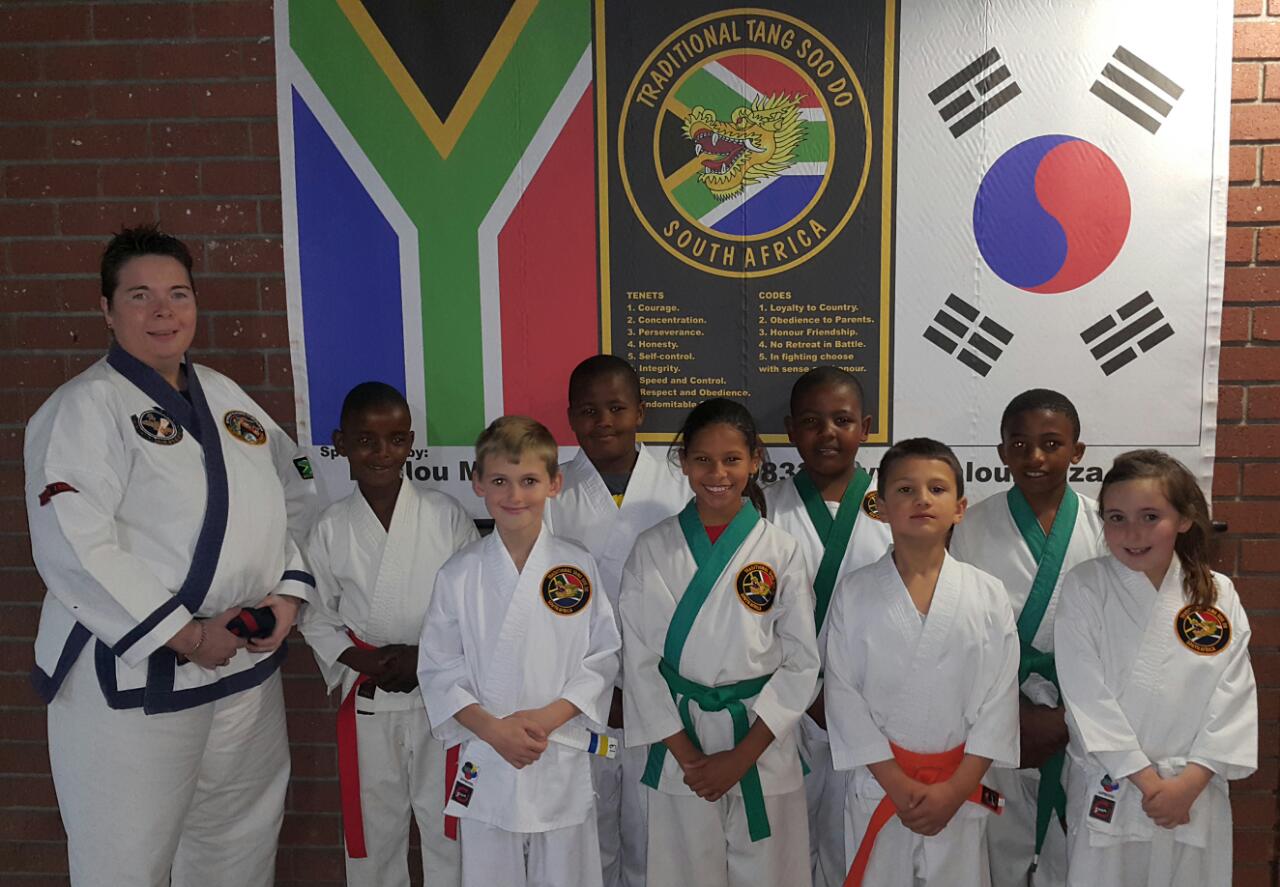 Juniors. Back: Master Louise Viviers - instructor; Thabiso Motsiumi - bronze, gold and silver; Onthatile Tshelmane - bronze and silver; Kholisile Xaba - silver and bronze; Nicholas Chihanga - silver, gold and bronze. Front: Jamie Eastes - bronze (2); Emma Witten - gold (2) and silver; William Avis - bronze and Maxelle Erasmus - bronze (2).