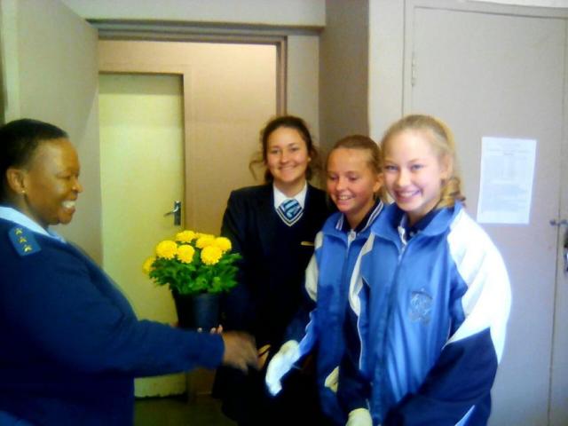 Captain Tshwaro Moeti receives fresh flowers from the girls.