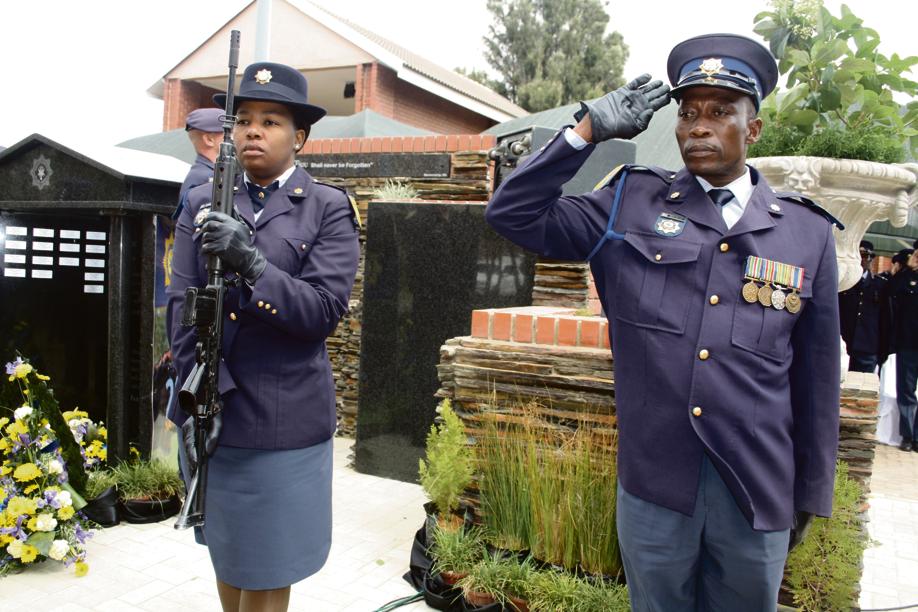 SAPS police officials pay tribute to the four fallen heroes. 