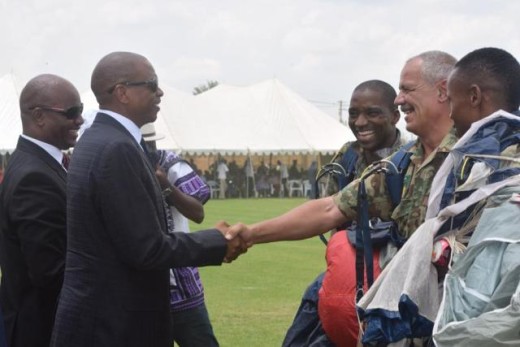 Premier Supra Mahumapelo greets and shares a joke with the three members of the SAPS task force. 