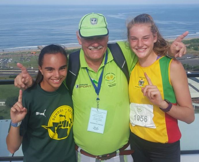 Gimmies se goue atletiekdogters! Miandi van Staden en Karmen Fouché vier hulle oorwinning saam met Gimnasium se atletiekorganiseerder, mnr. Arnold van der Merwe.