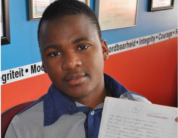 Thabang Moeng with his poetry book.
