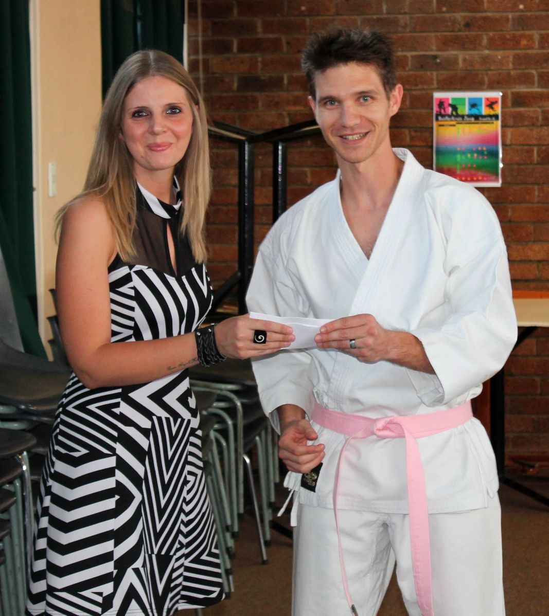 Stephan Steyn handing over the Dojo’s donation to CANSA representative, Isabel Minnaar.