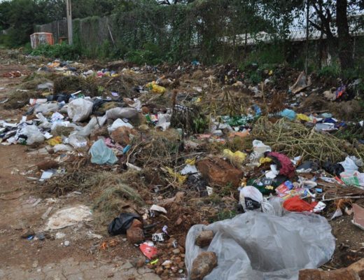 The piles of rubbish next to the school.