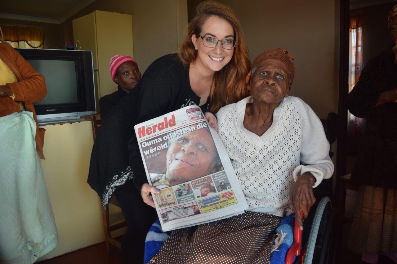 Marianke Saayman from the Potchefstroom Herald shows Martha her photo on the front page of last week's Herald. Photo: Selogile Leshage