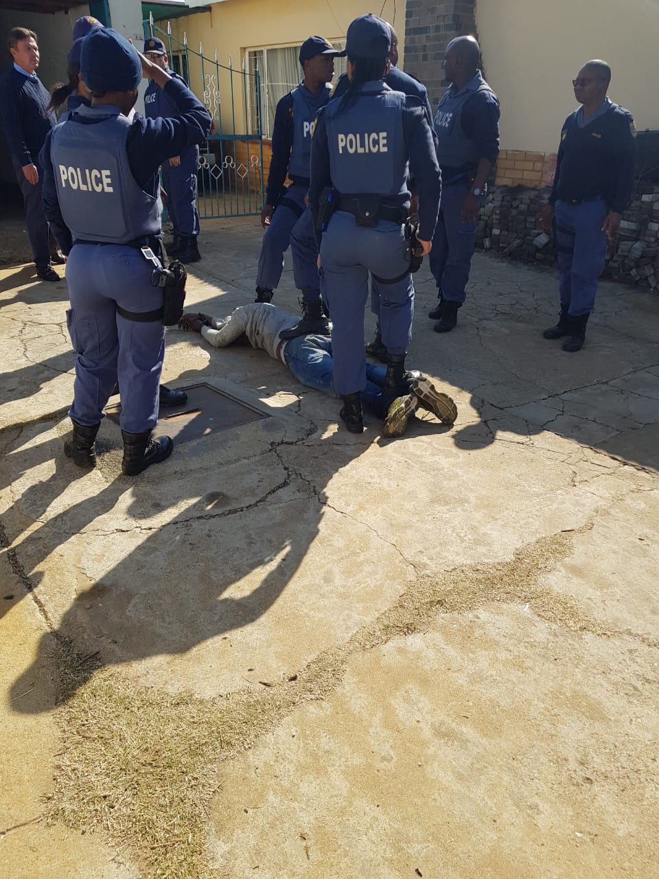 The police with one of the suspects who were arrested.