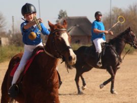 Local polocrosse player, Christopher Thornhill aims for goal.