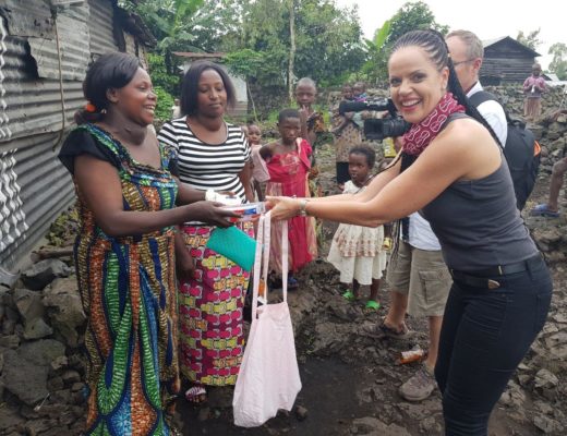 Janet Potgieter is handing out toiletries to two women in Goma, DRC, who suffer from goitre disease.