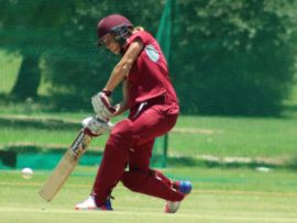Anneke Bosch goes down the track to smash the ball to the boundary