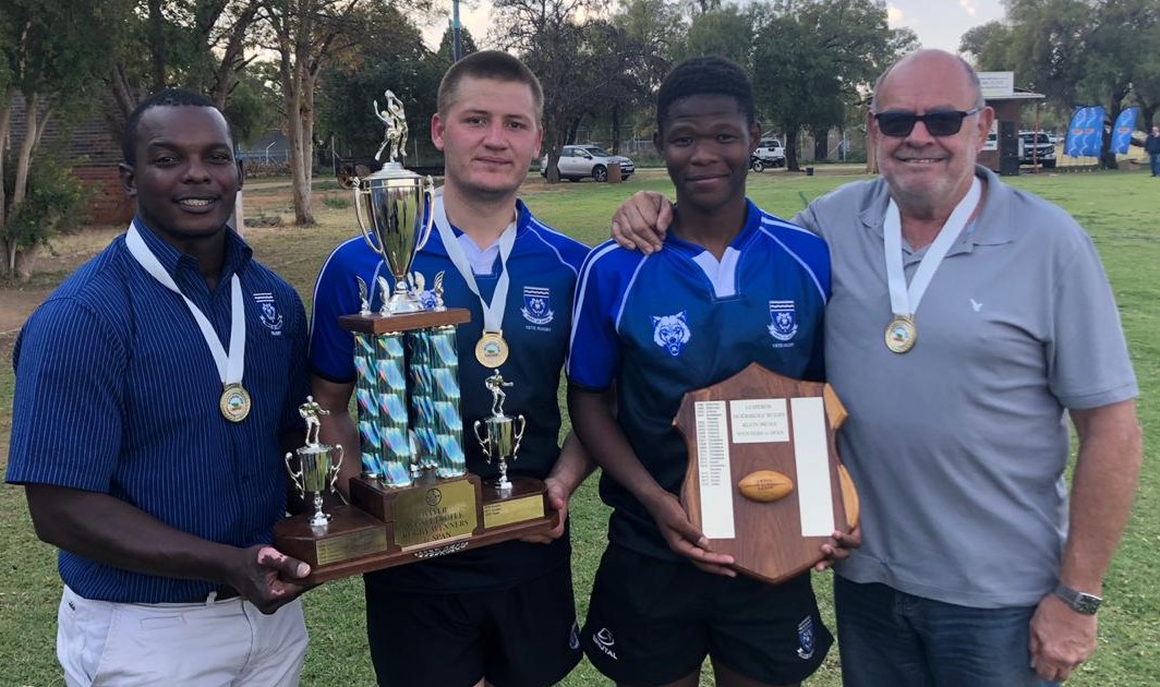 Ferdies se eerste rugbyspan is die Noordwes kleinskole-ligawenners. Hier is Joe Seerane (afrigter), Justin Engles (kaptein), Tshepo Matloko (heelagter) en Sias van Rensburg (hulpafrigter).