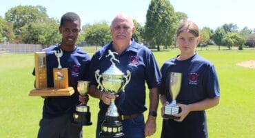 Headmaster with trophies.