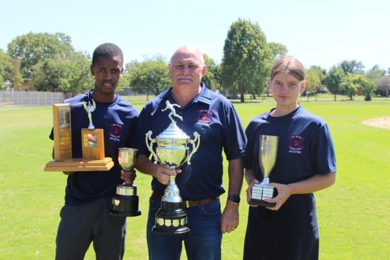 Headmaster with trophies.