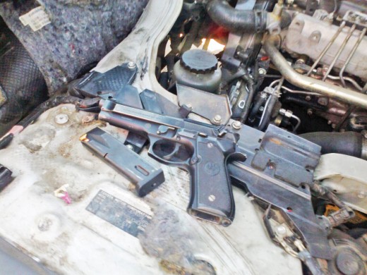 Police nabbed three suspects in possession of a stolen vehicle and three unlicensed firearms on Sunday. Photo: Mduduzi Mathebula. Insert: Firearms were hidden in the stolen vehicle’s engine. Photos: Supplied 