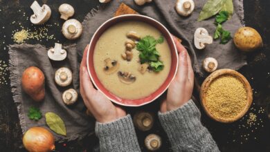 Women,Hands,In,A,Gray,Sweater,Holding,A,Bowl,Of