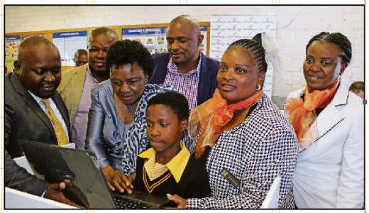 From left, acting executive business services for Sentech, Kopano Thage, Ward Councillor Silver Jantjie, deputy minister for Telecommunications and Postal Services Hlengiwe Mkhize who demonstrates to Kgomotso Jack and other Grade 6 pupils of Radipeu Primary School how to use a laptop. Also pictured are acting Emfuleni Mayor Khulu Malindi, Nandi Motloung (principal) and Limakatso Matobako (educator). Photo: Lazarus Dithagiso.