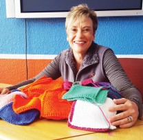 Belinda Vermaak Kleynhans with the mountain of squares knitted by her and her sister, Debbie.
