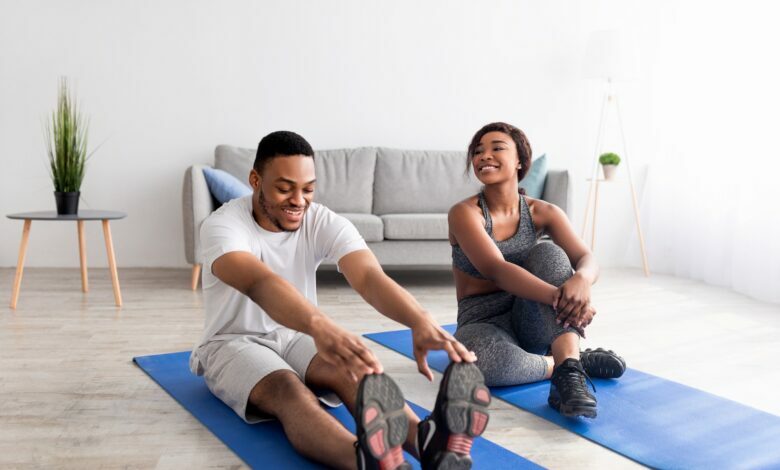 Fit,Black,Couple,Exercising,On,Yoga,Mats,At,Home,,Full