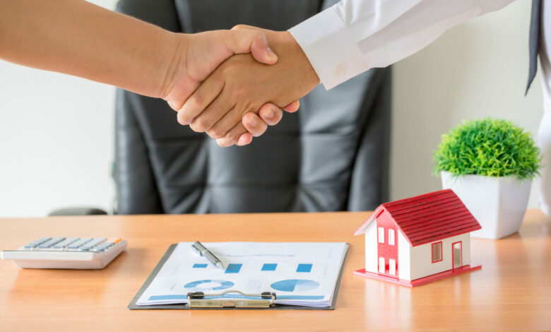 hands of agent and client shaking hands after signed contract bu