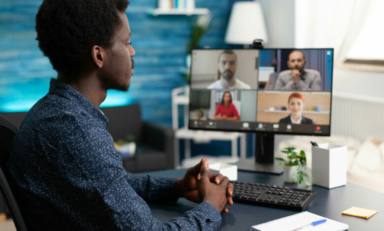 Man of african ethnicity using conference webcam communication
