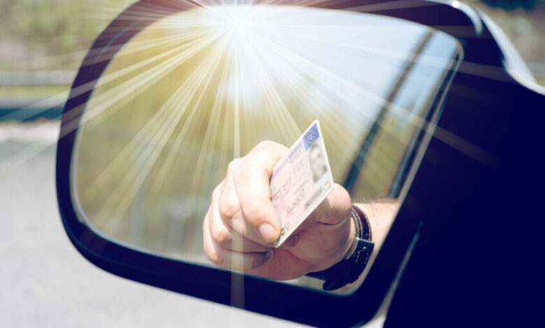126522544 - a man shows his driver's license
