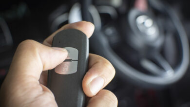 The driver's hand is pressed to the remote car keyless.