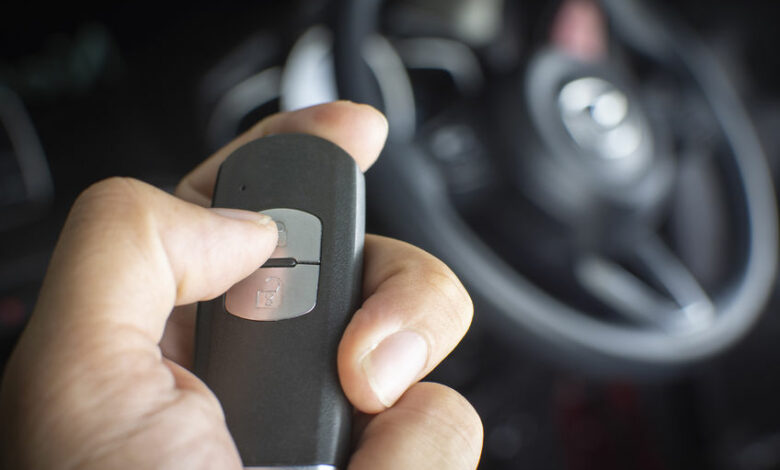 The driver's hand is pressed to the remote car keyless.