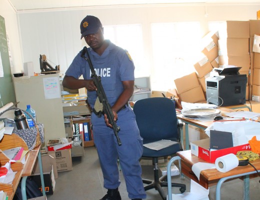 Consstable William Tshabangu shows one of the offices that criminals targeted during a burglary at Mountain View High School.