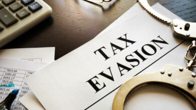 Papers about tax evasion on a desk. Tax avoidance concept.