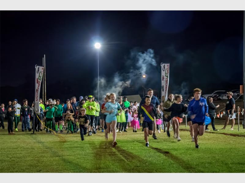 Residents braved the weather for a night of fun, food and glowing good times at the annual community market and fun run.