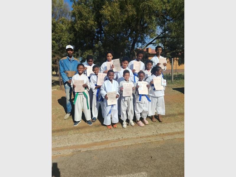 Ismaeel Arnold achieved his green belt after a standout kata performance during a rigorous five-hour testing session in Johannesburg.