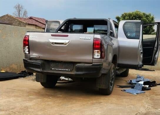 The Toyota Hilux was reported stolen. Suspects were found by metro cops stripping the vehicle.