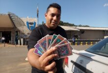Byron Mark Ghela, a local man who collects and plays the Yu Gi Oh! trading card game, with a few cards from his magnificent collection. Photo: Akheel Sewsunker