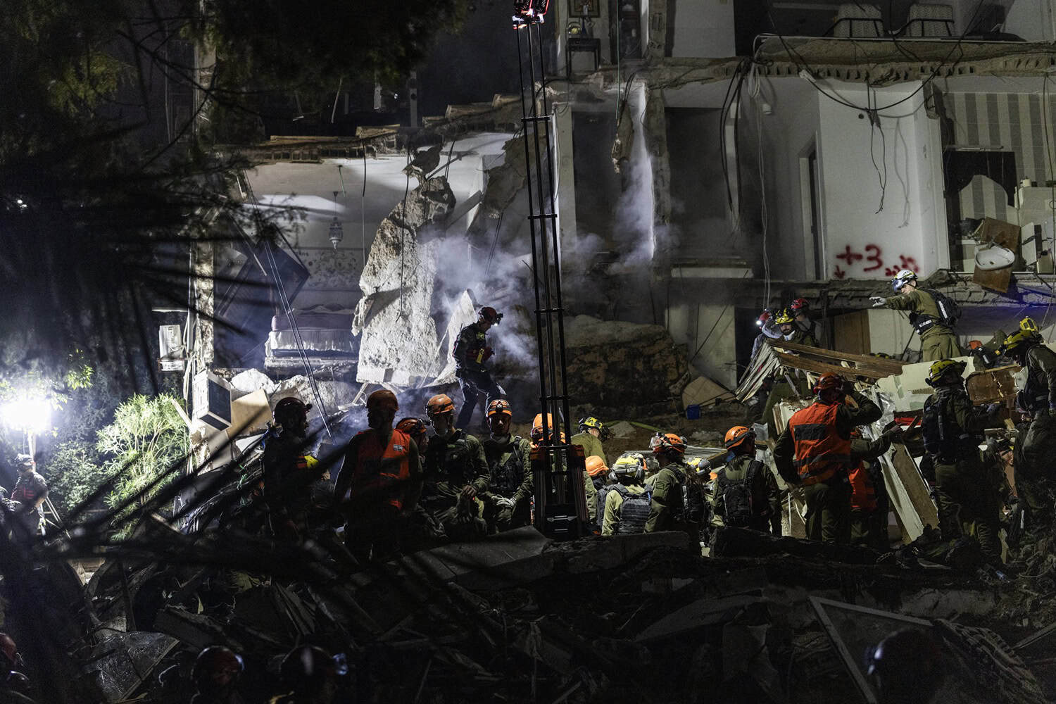 PICS | Israeli rescuers search for missing in building strike, two dead