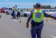 A national traffic police officer directs an oncoming vehicle to move to the side of the road at a road stop. Photo Road Traffic Management Corporation