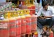 A man uses a mobile phone next to liquefied petroleum gas (LPG) cylinders outside a shop in Bengaluru on June 2, 2026 amid global energy crisis triggered by the Middle East war. (Photo by Idrees MOHAMMED / AFP)