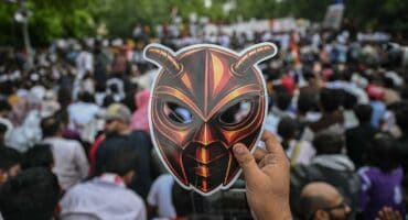 A Cockroach Janta Party (CJP) supporter holds a cockroach mask during a protest over alleged irregularities in the country's major examinations, in New Delhi on June 6, 2026. Photo: AFP