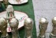 TOPSHOT - Souvenirs shaped like the FIFA World Cup trophy and traditional Mexican hats are displayed for sale on a street in Mexico City on June 8, 2026. (Photo by Yuri CORTEZ / AFP)