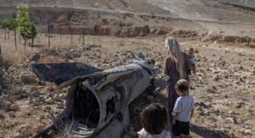 Israeli settlers look at a fallen rocket, outside a Jewish settler farm on the outskirts of Israeli-occupied West Bank city of Jericho on June 9, 2026, following Iranian and Iran-backed Houthi rebel attacks.