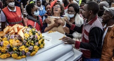 A relative hugs a portrait of a victim of the Utumishi Girls' Academy Senior School fire as she mourns with others during a memorial mass amid growing concern over a wave of school fires across Kenya at Gilgil Stadium in Gilgil, on June 12, 2026. Photo: AFP