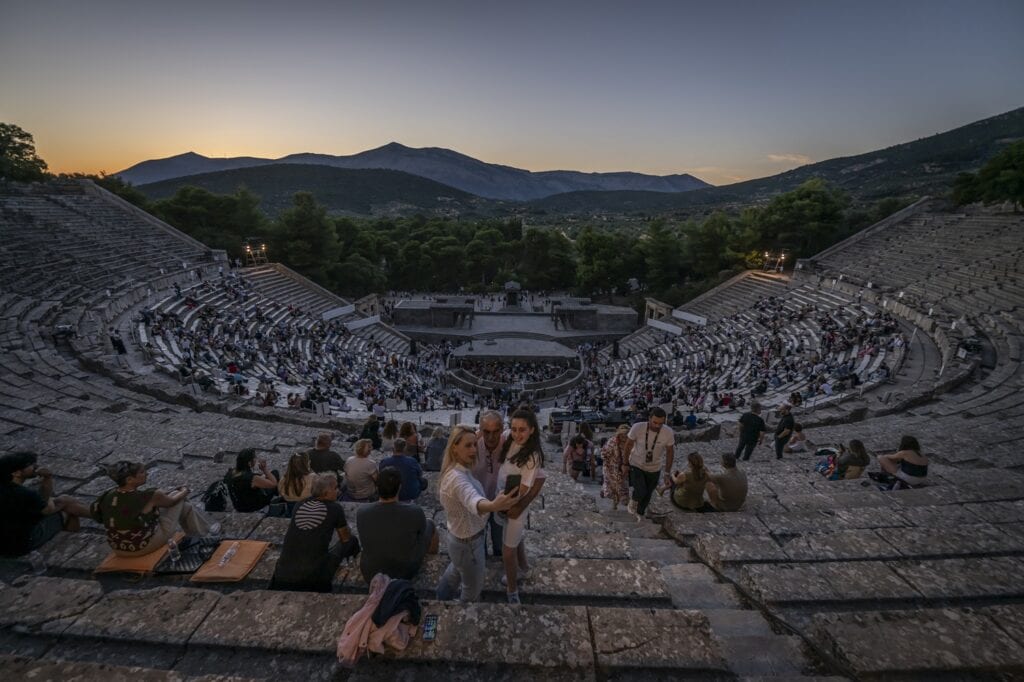 Spectators take a selfie before the start of the opera 'Medea' at the Ancient Greek theatre of former city Epidaurus, in Nea Epidavros on June 18, 2026. Photo: AFP