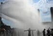 Police use water cannon to spray people with water as the arrive at the Olympic stadium for a concert of US singer Bruno Mars on June 28, 2026, in Berlin, as the German capital is expected to reach temperatures around 40 degrees Celsius during a heatwave in Europe.