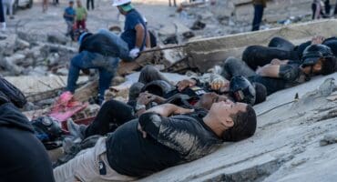 Rescuers and volunteers rest on the rubble of collapsed buildings in Caraballeda, La Guaira state, Venezuela, on June 28, 2026, following earthquakes.
