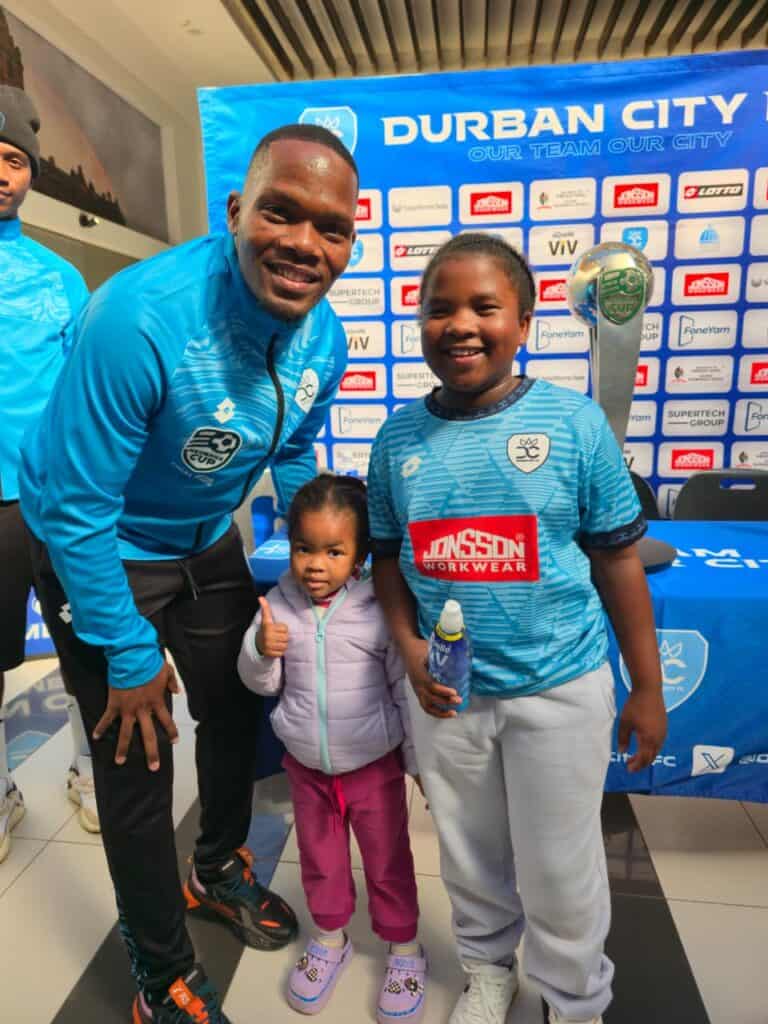 Durban City vice captain Mfanafuthi Mkhize with club fans Amazi Ntombela and little Omhle Nene during the celebration of the Nedbank Cup trophy. Photo: Chris Ndaliso