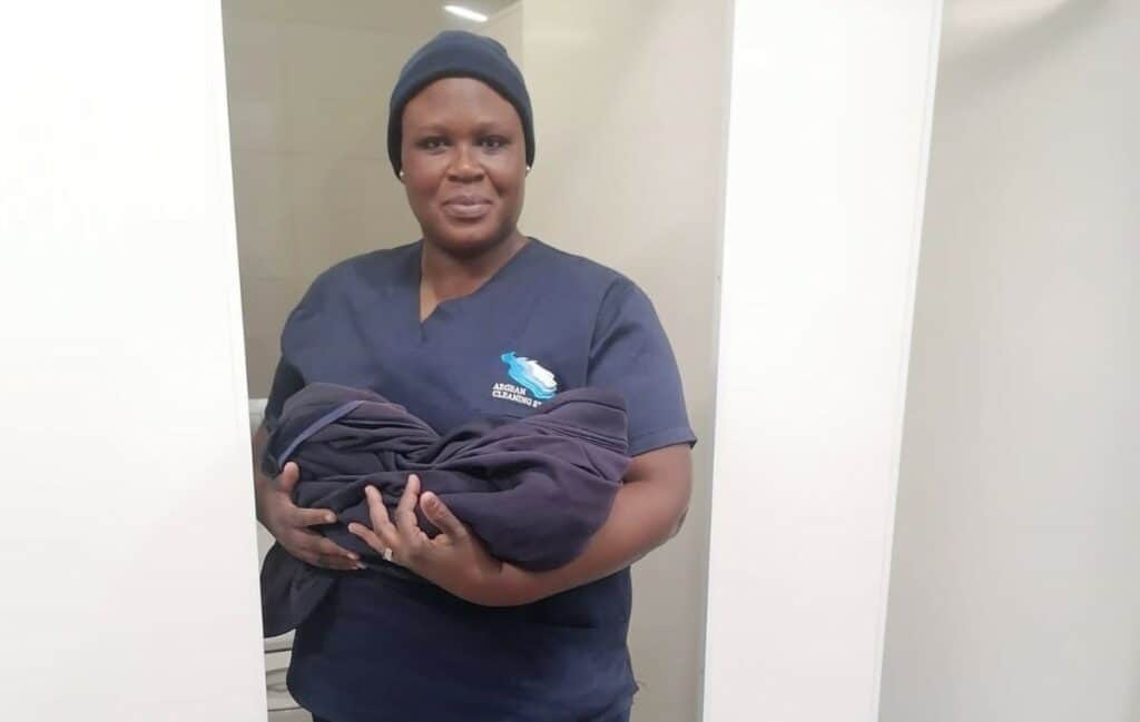 Flamingo Shopping Centre employee Mavis Sebjeng demonstrates how she held the baby. Behind her is the cubicle where he was born. Photo: Supplied